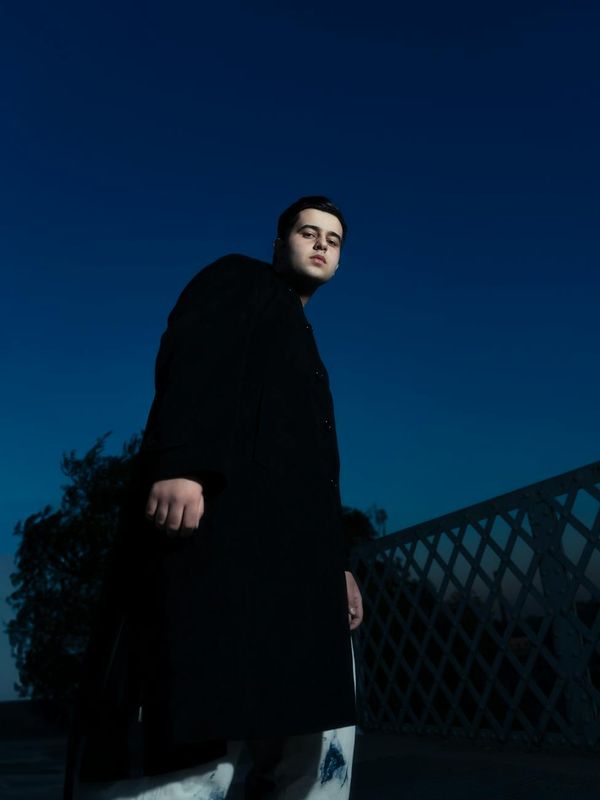 Silhouette of a man standing tall, indicating posture and confidence.